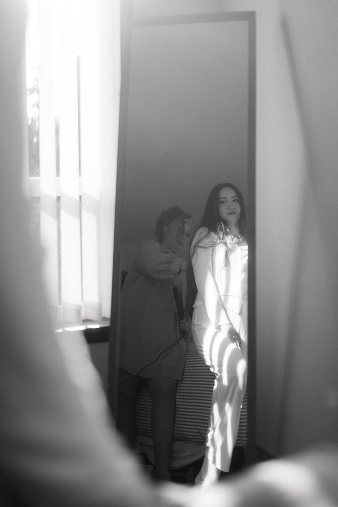 black and white photo of a woman in a mirror