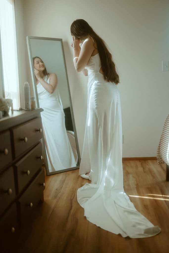 a bride getting ready next to a window