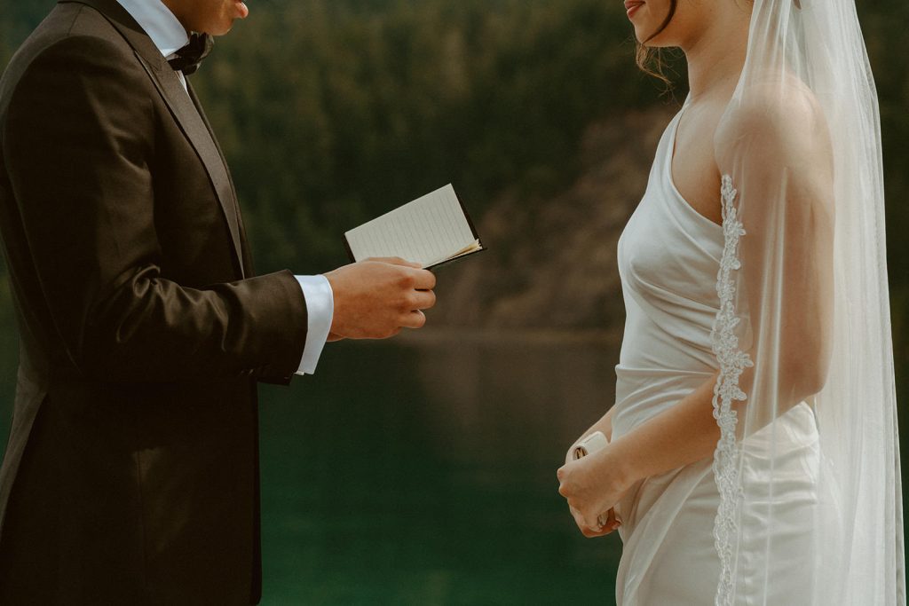 close up of a groom reading his vows