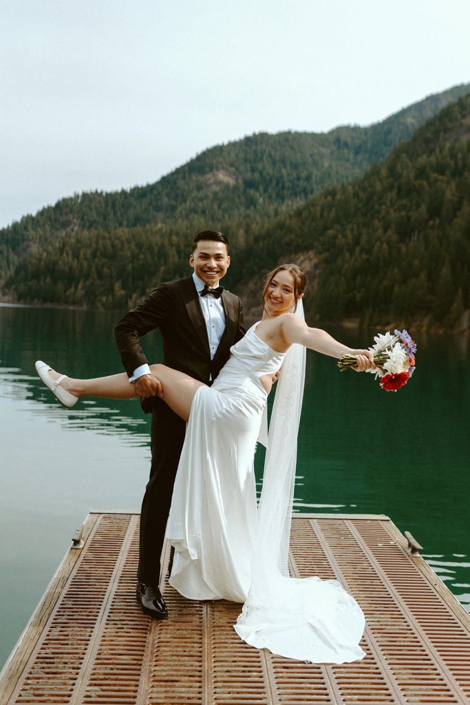 a groom and a bride are celebrating their Lake Crescent Elopement