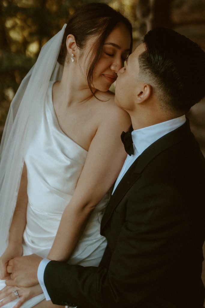 close up of a groom and bride kissing