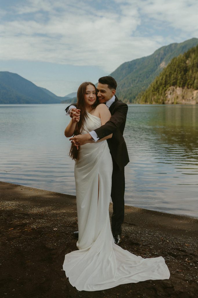 a groom and a bride hugging after their Lake Crescent elopement